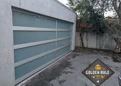 This New Contemporary Glass Aluminum Garage Door was installed in Laguna Beach Ca by Golden Rule Garage Door Inc.