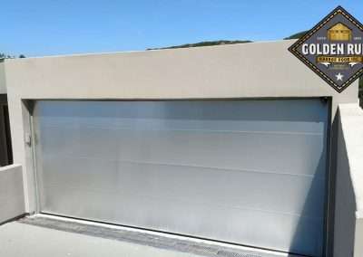 This New Contemporary Glass Aluminum Garage Door was installed in Laguna Beach Ca by Golden Rule Garage Door Inc.