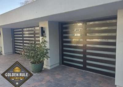 New Custom Wood Carriage House Garage Doors installed in San Juan Capistrano CA by Golden Rule Garage Door Inc. Contemporary, Stain-Grade Mahogany