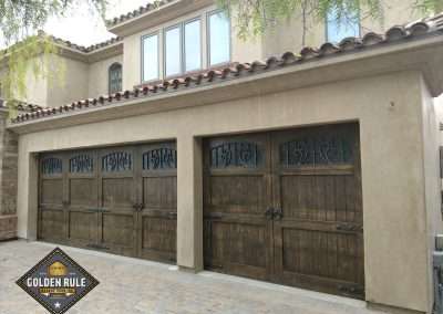 New Custom Wood Carriage House Garage Doors installed in San Juan Capistrano CA by Golden Rule Garage Door Inc. Tuscan Knotty Alder, Stain-Grade