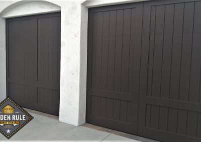 New Custom Wood Carriage House Garage Doors installed in Laguna Beach CA by Golden Rule Garage Door Inc. Spanish Paint-Grade