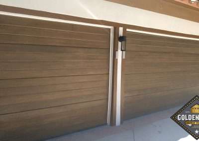 New Custom Wood Carriage House Garage Doors installed in San Juan Capistrano CA by Golden Rule Garage Door Inc. Plank Style Stain-Grade Mahogany