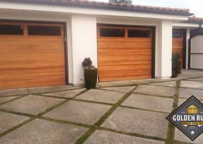 New Custom Wood Carriage House Garage Doors installed in Monarch Beach CA by Golden Rule Garage Door Inc. Contemporary Plank, Stain-Grade Mahogany