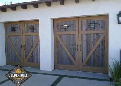 New Custom Wood Carriage House Garage Doors installed in Monarch Beach CA by Golden Rule Garage Door Inc. Provincial Style Reclaimed Wood with Cedar Overlay Stain-Grade