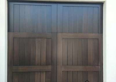 New Custom Wood Carriage House Garage Door installed in San Juan Capistrano CA by Golden Rule Garage Door Inc. Contemporary Spanish Stain-Grade Mahogany