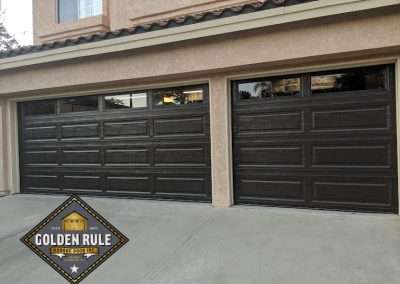 These Unique Traditional Long Panel Garage Doors in Black with L100 windows were installed in Orange County CA by Golden Rule Garage Door Inc.