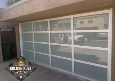 This New Contemporary Glass Aluminum Garage Door was installed in Laguna Beach Ca by Golden Rule Garage Door Inc.