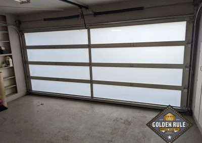 This New Contemporary Glass Aluminum Garage Door was installed in Laguna Beach Ca by Golden Rule Garage Door Inc.