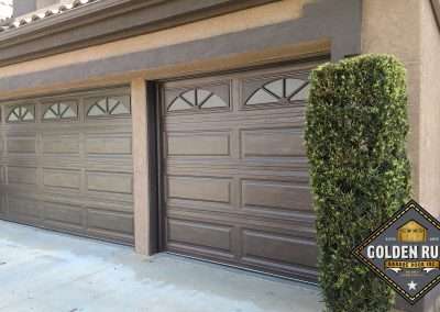 These Unique Traditional Long Panel Garage Doors in Brown with obscure privacy glass windows were installed in Orange County CA by Golden Rule Garage Door Inc.