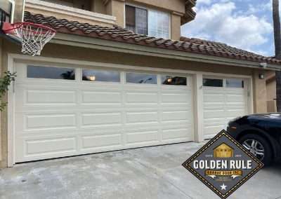 These Steel-Back Unique Traditional Long Panel New Garage Doors in Almond with L100 windows with 10 R-value were installed in Orange County CA by Golden Rule Garage Door Inc.
