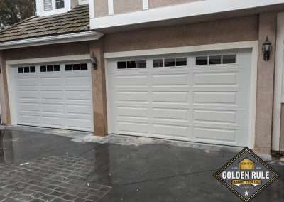 These Insulated 3-Layer Steel-back Unique Traditional Long Panel New Garage Doors in White with L595 windows with 10 R-value were installed in Laguna Hills CA by Golden Rule Garage Door Inc.