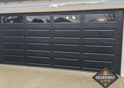 This 3-Layer Steel-back Unique Traditional Long Panel New Garage Door in Black with L100 windows with 10 R-value was installed in Orange County CA by Golden Rule Garage Door Inc.
