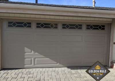 This Unique Traditional Long Panel New Garage Door in Sandstone with L499 windows was installed in Orange County CA by Golden Rule Garage Door Inc.