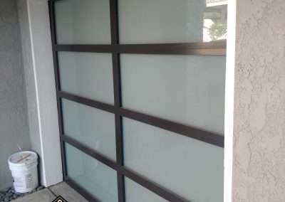 This New Contemporary Glass Aluminum Garage Door was installed in Dana Point Ca by Golden Rule Garage Door Inc.