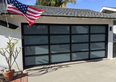 This New Contemporary Glass Aluminum Garage Door was installed in Dana Point Ca by Golden Rule Garage Door Inc.