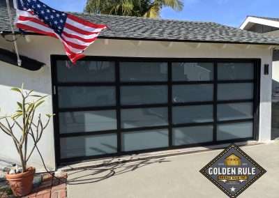 This New Contemporary Glass Aluminum Garage Door was installed in Dana Point Ca by Golden Rule Garage Door Inc.